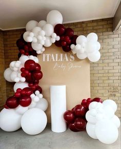 balloon arch with white and red balloons in front of a sign that says italia's by any name