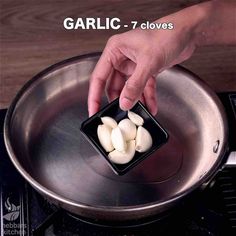 someone is adding garlic to a saucepan on the stove top with text overlay that reads garlic 7 cloves