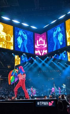 the stage is lit up with brightly colored lights