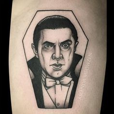 a man in a tuxedo tattoo on the leg