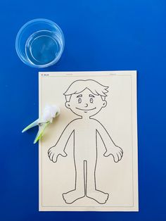 a paper cut out of a man with a flower next to it on a blue surface