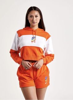 This Sport DNA Fleece Hoodie from Nike Sportswear takes inspiration from the brand's vintage styles. It features a colorful front logo print and is done in a boxy, oversized fit. Swoosh graphic printed at front French terry fabric for comfort Ribbed sleeve cuffs and hem Attached hood with adjustable drawstring Cropped length Color Shown: White/Orange Style: #DM6758-817 MSRP: $65 Nike Cropped Hoodie, Orange Pullover, Funnel Neck Hoodie, Women's Sportswear, Womens Air Jordans, Nike Zip Up, Hoodie Xxl, Nike Sweatshirts, French Terry Fabric