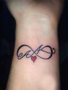 a wrist tattoo with an infinite love symbol