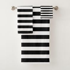 black and white striped towels hanging on a towel rack