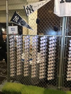 baseball memorabilia is displayed behind a chain link fence at the new york yankees'game