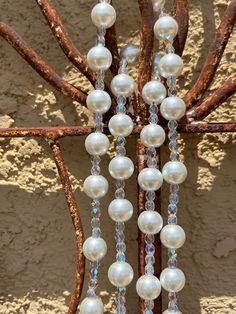 This Wedding Gift Rosary symbolizes the unity of marriage between the bride and groom and the union of the two becoming one in Christ. What great blessings it gives to that special couple and their new life together! This elegant pearl glass bead rosary was made handmade in the USA using 10mm White Pearl glass beads with Czech fire-polished AB crystal glass accent beads, and your choice of Our Father beads (pearl beads or Mother of Pearl Cross), your choice of rosary center and if you want metal end caps on the pearl beads.  A gorgeous 3" silver Benedictine crucifix completes the rosary beautifully. The length of the rosary hanging up is 31 inches from top to bottom. Comes in a velvet drawstring bag. White Hand-strung Wedding Necklaces, White 8mm Beads Jewelry For Anniversary, White Hand-strung Necklaces For Wedding, Classic Wedding Beaded Necklace With Polished Beads, Hand-strung Pearl Wedding Necklaces, Classic Polished Beaded Necklaces For Wedding, Hand-strung Pearl Necklaces For Weddings, Spiritual Polished Bead Necklaces For Weddings, Adjustable Wedding Necklace With Large Beads