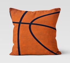 an orange and black pillow with a basketball on it