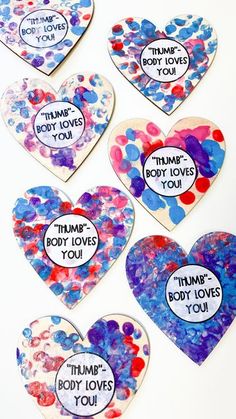 four heart shaped paper hearts with words on them that say, think about love and body loves you