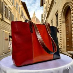 This bag has been made of the best genuine leather by local master crafters of Florence in Italy, designed for women who only accept premium Italian quality and luxury leather bags and modern Italian fashion. . Sizes: Width:   39  cm/15.25 inch Height:  25  cm/9.75 inch Depth:   14  cm/5.50 inch Color: multicolor The Story of this bag :  Once upon a time, there was an Italian leather goods store run by a skilled artisan named Marco. Marco had a talent for creating unique and high-quality handmade leather bags. His bags were known for their superior quality, durability, and exquisite design. One of Marco's most popular creations was his Italian flog bag, a vintage shoulder leather bag that was perfect for work and daily use. Made from the finest Italian leather, this multicolored bag was a Italian Leather Bag As Gift, Italian Leather Bag As A Gift, Italian Leather Bags In Cognac, Italian Leather Bags In Cognac Color, Multi Colored Bag, Handmade Leather Bags, Luxury Leather Bag, Italian Bags, Handmade Handbags