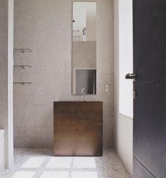 a bathroom with a sink, mirror and tiled floor