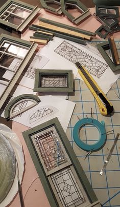 several frames and tools are laying on the table with some cut out designs around them