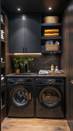 a washer and dryer in a small room with dark colored cabinets, wood flooring and shelves