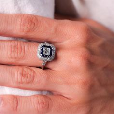 a woman's hand with a diamond and sapphire ring