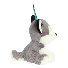 a gray and white stuffed animal with a toothbrush in it's mouth on a white background