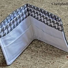 an open wallet sitting on top of a counter next to a tablecloth covered floor