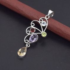 Welcome https://uniquejewelstudio.etsy.com Stone: Natural Multi Gemstone Shape: Pear Shape Metal:- Pure 925 Sterling Silver Pendant Weight : 4 to 5 gm ( Approx ) Stock Code : SP-522 Elevate your jewelry collection with this stunning Amethyst Citrine Multi Gemstone Pendant. Crafted from high-quality 925 sterling silver, this pendant showcases the perfect blend of elegance and vibrant colors.Add this exquisite Amethyst Citrine Multi Gemstone Pendant to your collection today and enjoy its timeless Sterling Silver Pendant With Gemstone Accents, Silver Citrine Gemstones With Gemstone Accents, Sterling Silver Multi-stone Pendant Gemstones, Sterling Silver Multi-stone Pendant, Necklace Birthstone, Sterling Silver Necklace Pendants, Silver Pendant Necklace, Birthstone Jewelry, Pear Shape