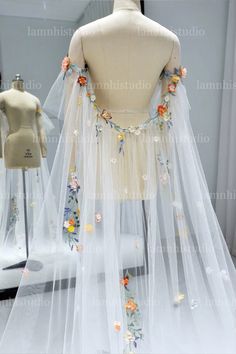 a mannequin wearing a veil with flowers on it