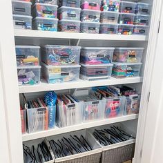 an organized closet with plastic bins, baskets and other crafting supplies on shelves