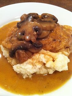 mashed potatoes with mushrooms and gravy on top