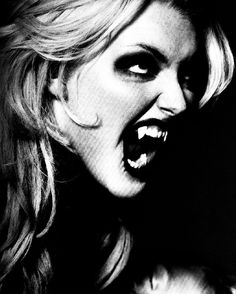 a black and white photo of a woman with her mouth open