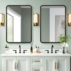 a bathroom with two sinks and mirrors on the wall