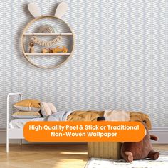 a room with a bed, teddy bear and wallpaper on the walls that says high quality peel & stick traditional non - woven wallpaper