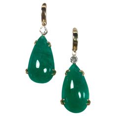 Stunning hanging earrings comprising of two pear cabochon-cut natural emeralds weighing 35.54 carats. Excellent medium vivid green color. The emeralds are certified by CDTEC stating that they are of Colombian origin with moderate clarity enhancement. The earrings are also embellished with two round diamonds, 0.36 carat G/ VS2. The mounting is handmade in 18K yellow gold and the Top hoops are 14K gold. Total Gemstone weight 35.90 carats. Each emerald comes with a certificate Dimensions Approx. Le