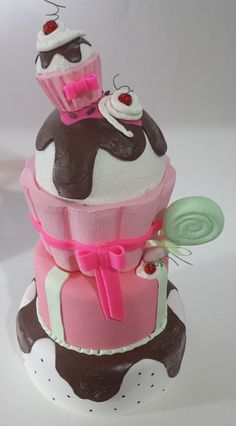 three tiered cake with pink and brown icing