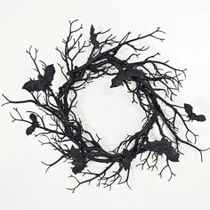 a wreath made out of branches with birds on it