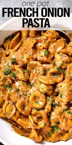 a white bowl filled with pasta covered in sauce