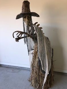 a scarecrow with a hat and long hair