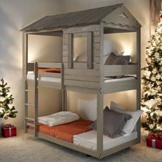 there is a bunk bed with a house on the top and two beds below it