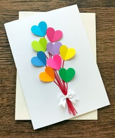 a bunch of heart shaped paper on top of a white card