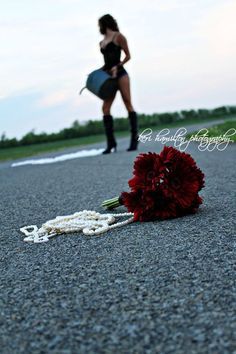 a bouquet of flowers on the ground next to a woman