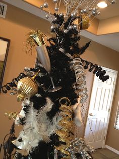 a black and white christmas tree with gold ornaments