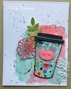 a close up of a card with a coffee cup and flowers on the side,