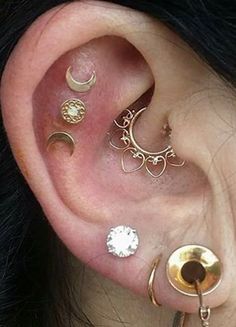 an ear with three different types of piercings on it