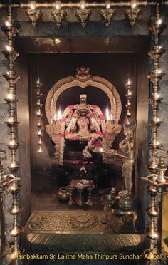 an idol with candles in the middle of it, surrounded by other decorations and lights