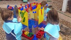 two young children playing with an outdoor game