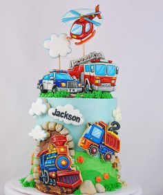 a birthday cake decorated with cars and trucks