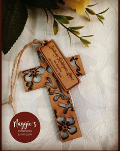 a wooden cross with flowers on it