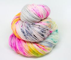 multicolored skeins of yarn sitting on top of each other