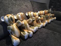 stuffed teddy bears are lined up on the couch