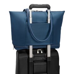 Surprisingly roomy for such a sleek silhouette, this tote expands and is designed with thoughtful compartments and pockets to transport everything from your laptop to your travel essentials gym clothes—while making it all easy to grab on the go. Fits up to a 13" laptop. SKU: PT225X-5 Laptop Compartment Slip-Through Back Panel INTERIOR FEATURES Bottom zippered expansion that adds 4" of packing capacity when you need it. Cavernous main compartment holds an assortment of items both large and small. Internal organizer with two slip pockets, business card slip pockets, and pen loops. Keep your water bottle secure but accessible with an interior pocket. Tech section in main compartment includes an integrated padded laptop sleeve protects most 15" computers and slip pocket for a tablet. Fabric li