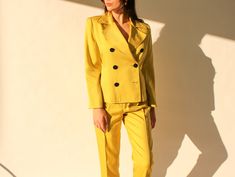 "FREE DOMESTIC SHIPPING Absolutely beautiful vintage 90s butter soft 100% silk Linda Allard for Ellen Tracy fluorescent yellow pant suit. This incredible set is flawless in design. The broad shoulder double breasted blazer is cropped and finished with large black disc buttons. Fitting perfectly to show off the high waisted pleated slacks that fall to a tapered hemline. The slacks are pocketless giving and overall flattering shape throughout the entire suit. This piece is versatile enough to be w Chartreuse Suit Women, Yellow Fitted Blazer With Lapel Collar, Vintage Yellow Formal Blazer, Classic Yellow Blazer With Button Closure, Yellow Long Sleeve Blazer With Button Closure, Yellow Pants, Ellen Tracy, Cropped Blazer, Double Breasted Blazer