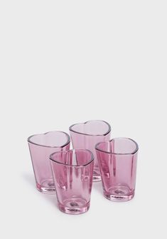 four pink glasses sitting next to each other