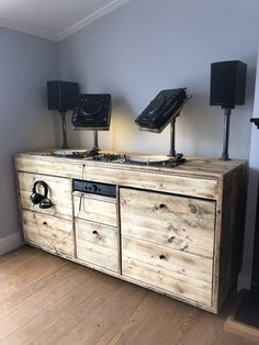 a large wooden cabinet with speakers on top