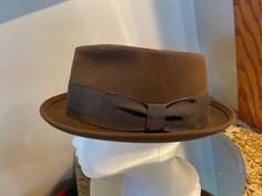 Here is a brown felt Fedora from John B Stetson with brown band.   Size is 7.25.  Brand new and never worn!  Sold at Levin Hat Company in St. Louis.  You won't find a nicer hat!  Add to your wardrobe or give a beautiful gift! Classic Adjustable Brown Felt Hat, Classic Brown Formal Hat Band, Fitted Brown Felt Hat With Flat Brim, Adjustable Brown Felt Hat With Flat Bill, Brown Formal Hat For Fall, Formal Brown Hat For Fall, Adjustable Brown Fedora With Flat Bill, Fitted Brown Fedora For Winter, Western Style Brown Hat Bands For Formal Occasions