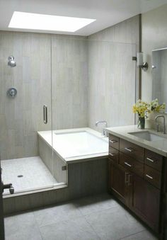 a bathroom with a sink, shower and bathtub