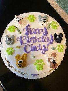 a birthday cake decorated with animals and the words happy birthday ciddyy on it